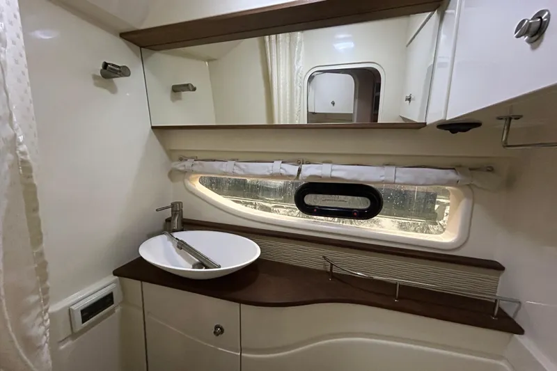 Slide: The Image of Luxurious bathroom interior of 2014 Sea Ray 350 Sundancer yacht with modern sink and mirror. - 17