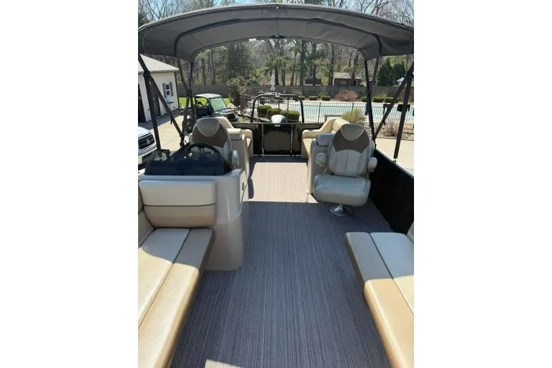 Slide: The Image of 2022 Veranda Vista View22RC TT pontoon boat interior with beige seating and canopy. - 10