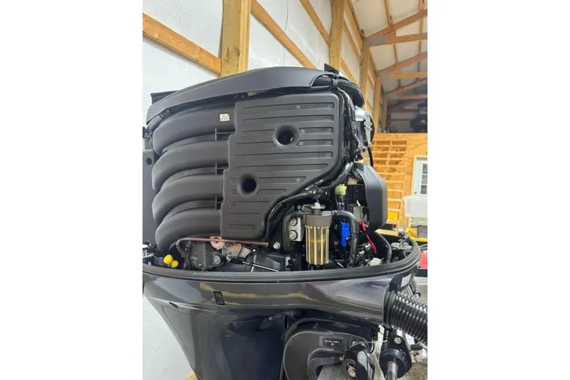 Slide: The Image of Close-up of a 2022 Veranda Vista View22RC TT boat engine in a workshop setting. - 16