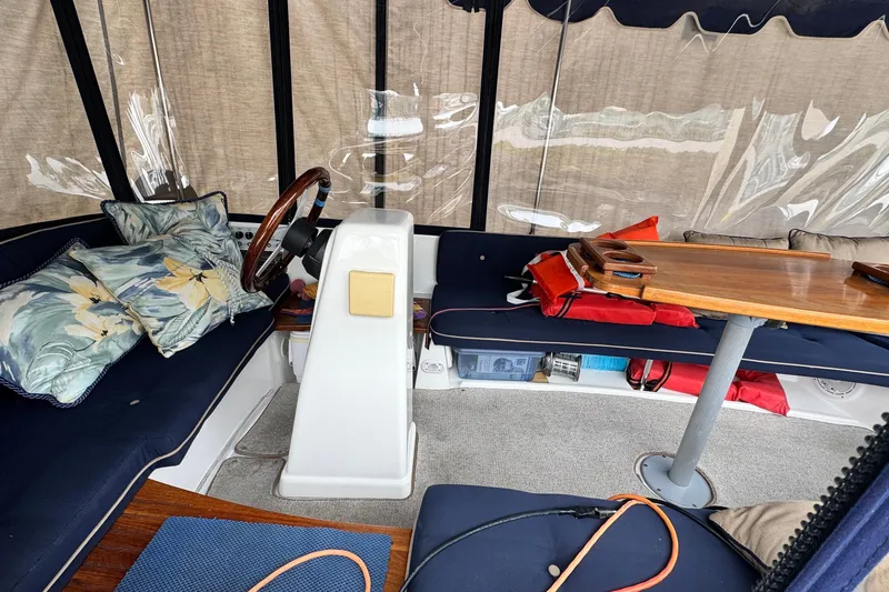 Slide: The Image of Interior of a 2003 ElectraCraft 16 LS boat with seating and steering wheel. - 3
