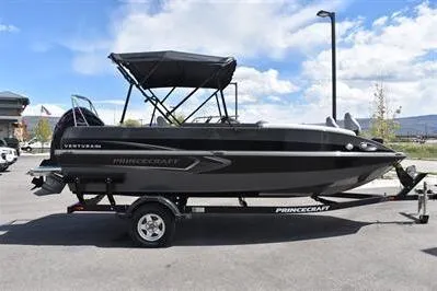 The Image of 2026 Princecraft Ventura 194 boat on trailer, black exterior, parked outdoors under blue sky. - 0