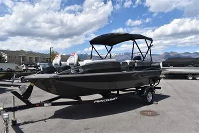 Slide: The Image of 2026 Princecraft Ventura 194 boat on trailer under cloudy sky. - 2