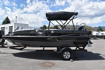 Slide: The Image of 2026 Princecraft Ventura 194 boat on trailer, parked outdoors under a partly cloudy sky. - 3
