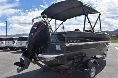 Slide: The Image of 2026 Princecraft Ventura 194 boat with canopy on trailer, parked outdoors. - 4