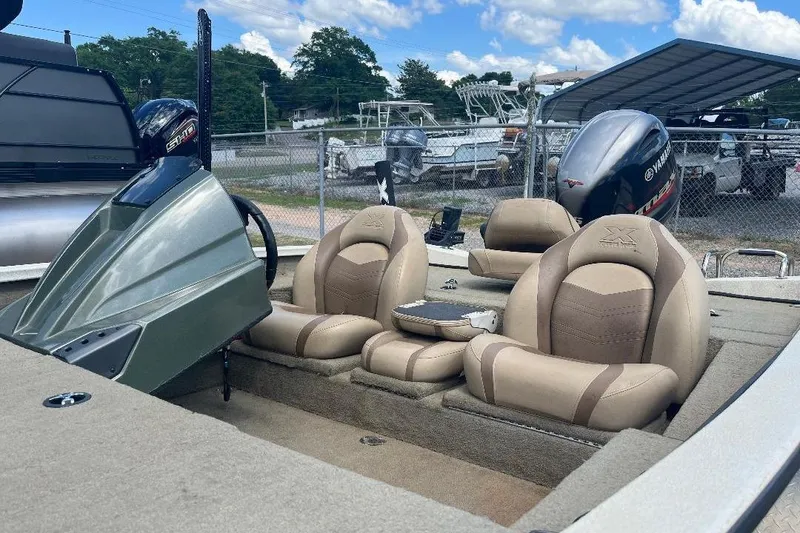 Slide: The Image of Xpress X17 Pro 2018 boat interior with beige seats and Yamaha outboard motor. - 13