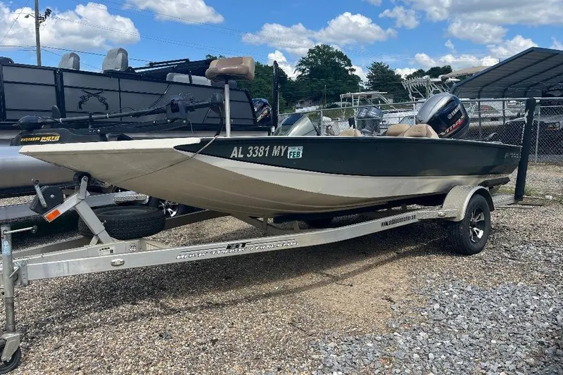Slide: The Image of 2018 Xpress X17 Pro boat on trailer, parked outdoors under a blue sky. - 18
