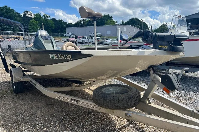 Slide: The Image of 2018 Xpress X17 Pro boat on trailer, parked outdoors under cloudy sky. - 2