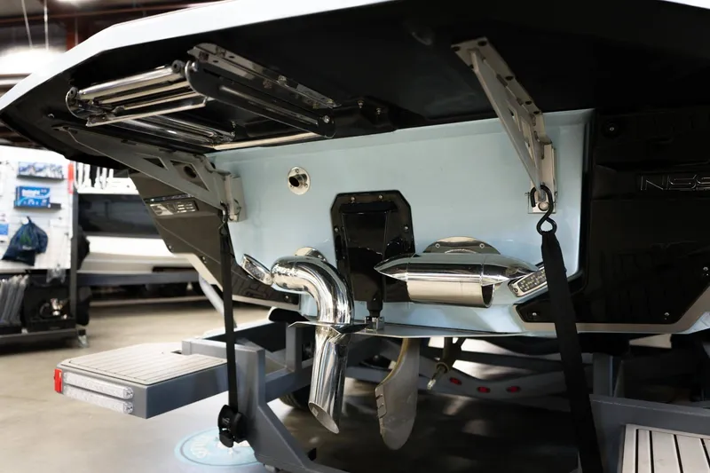 Slide: The Image of Rear view of 2026 Nautique G23 boat in storage. - 16