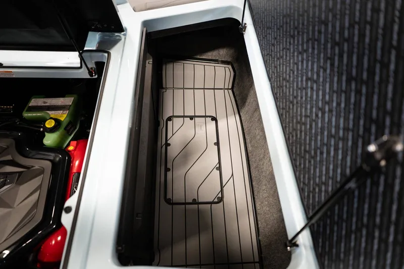 Slide: The Image of 2026 Nautique G23 storage compartment interior view. - 17