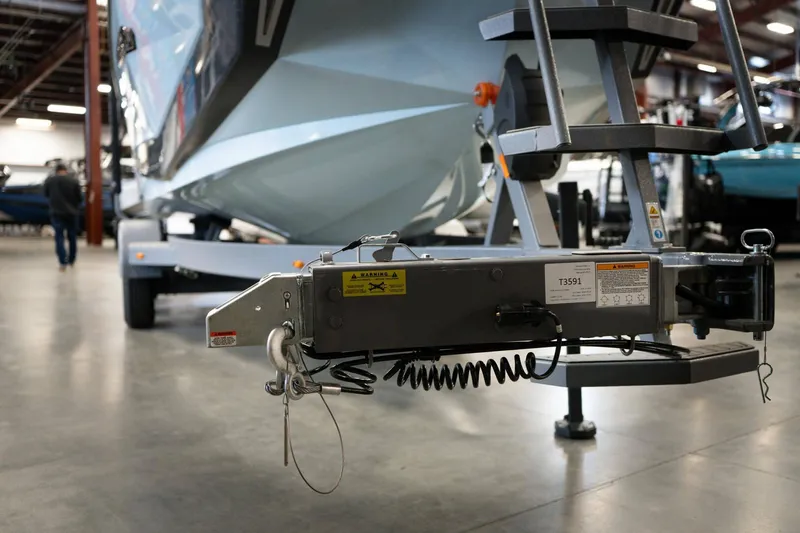 Slide: The Image of 2026 Nautique G23 boat on trailer in warehouse. - 24