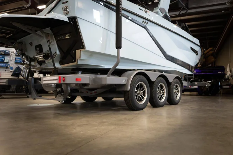 Slide: The Image of 2026 Nautique G23 boat on trailer in warehouse. - 26