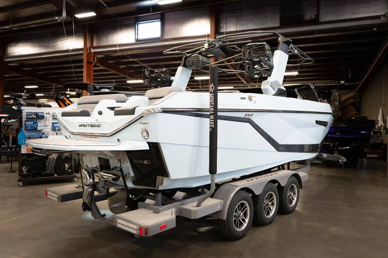 Slide: The Image of 2026 Nautique G23 boat on trailer in warehouse. - 3