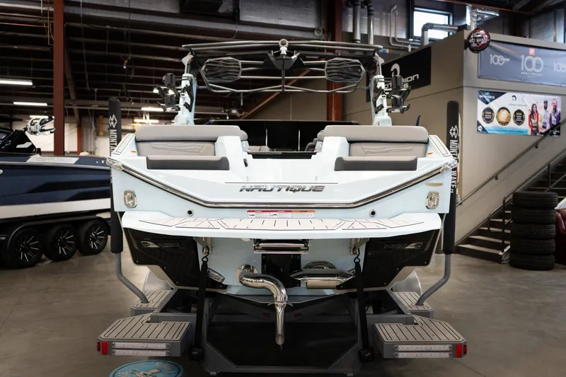 Slide: The Image of Rear view of 2026 Nautique G23 boat in showroom. - 4