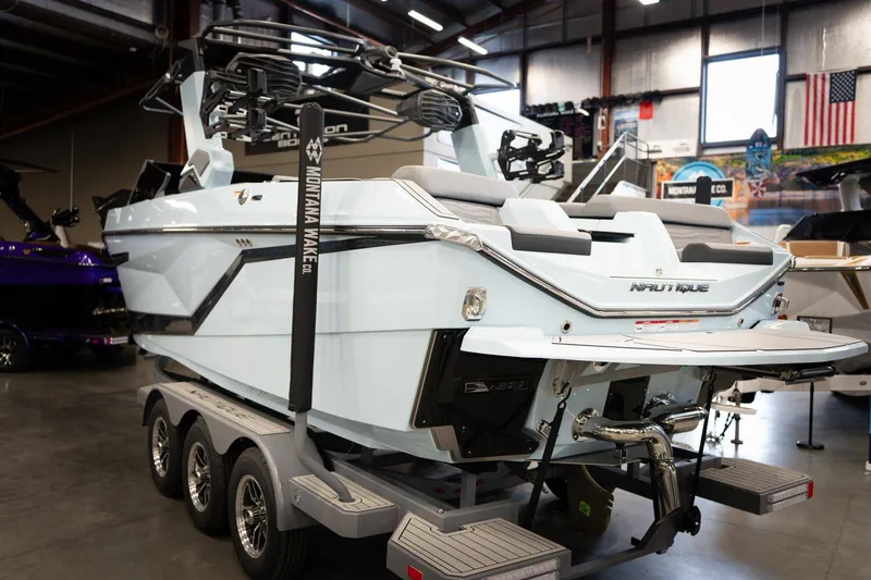 Slide: The Image of 2026 Nautique G23 boat in showroom on trailer. - 5