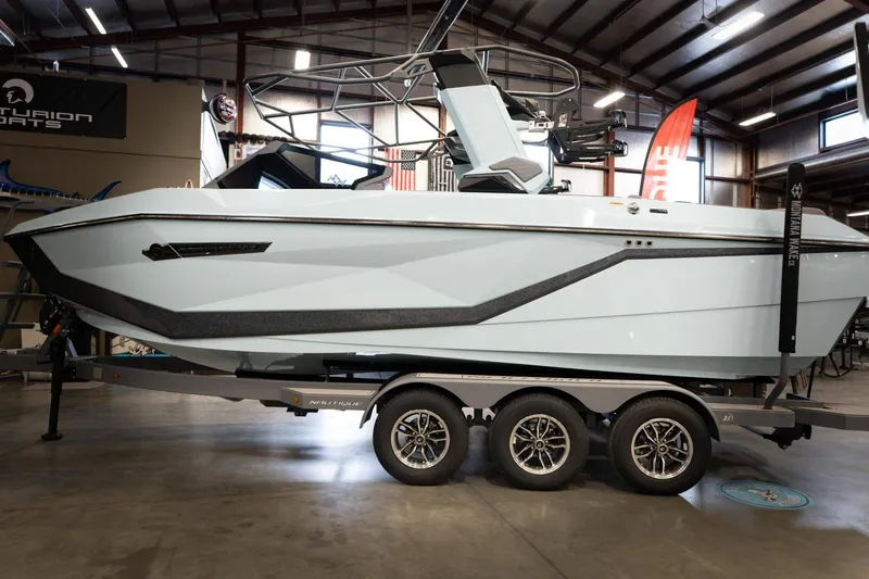 Slide: The Image of 2026 Nautique G23 boat displayed in a showroom. - 6