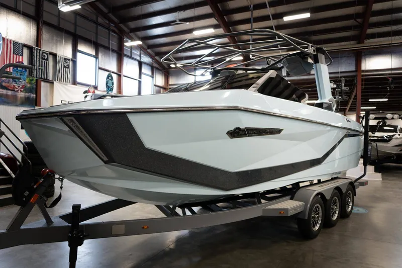 Slide: The Image of 2026 Nautique G23 boat in a warehouse on a trailer. - 7