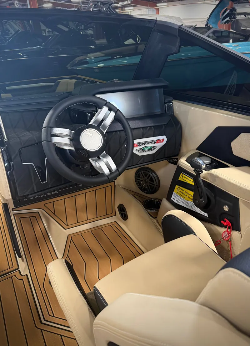 Slide: The Image of Interior of 2026 Nautique Super Air Nautique S23 with modern helm. - 11