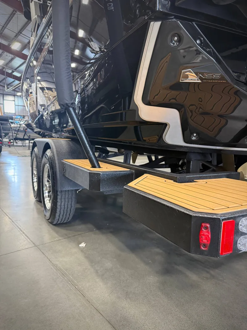 Slide: The Image of 2026 Nautique Super Air Nautique S23 on trailer in warehouse. - 20