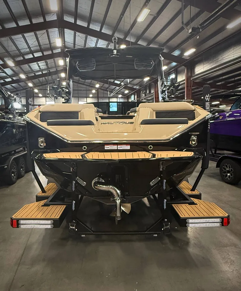 Slide: The Image of Rear view of 2026 Nautique Super Air Nautique S23 in a warehouse. - 4