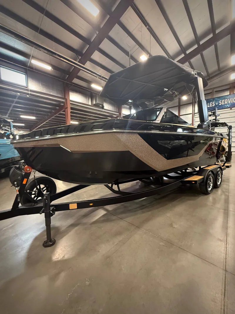 Slide: The Image of 2026 Nautique Super Air Nautique S23 boat in warehouse. - 6