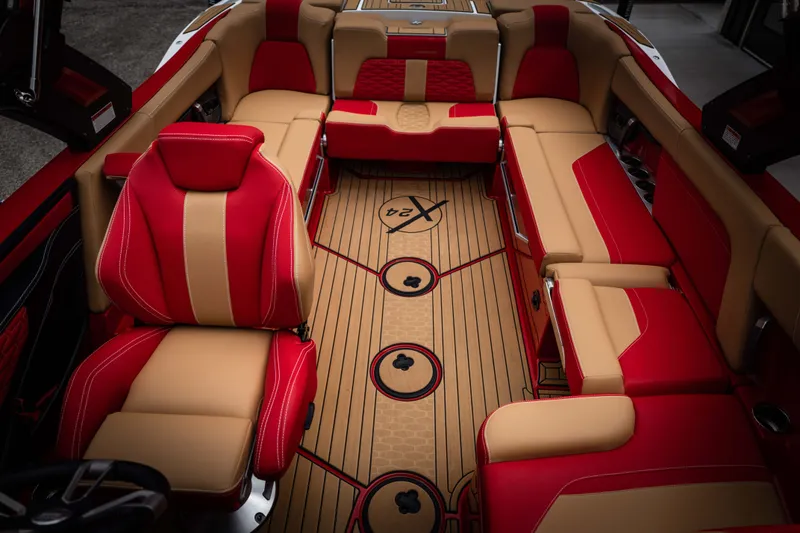 Slide: The Image of Interior of 2023 MasterCraft X24 with red and beige seating. - 10
