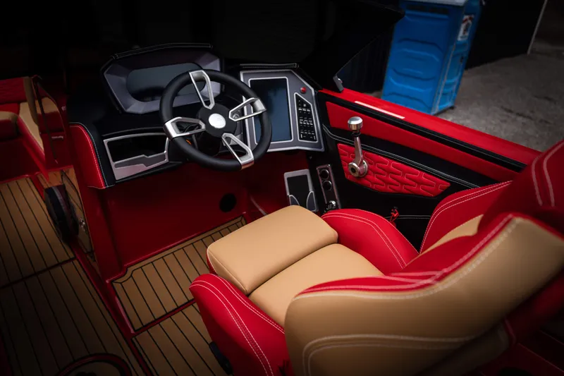 Slide: The Image of 2023 MasterCraft X24 interior with red and beige seating. - 14