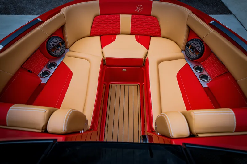 Slide: The Image of Interior of 2023 MasterCraft X24 boat with red and beige seating. - 17