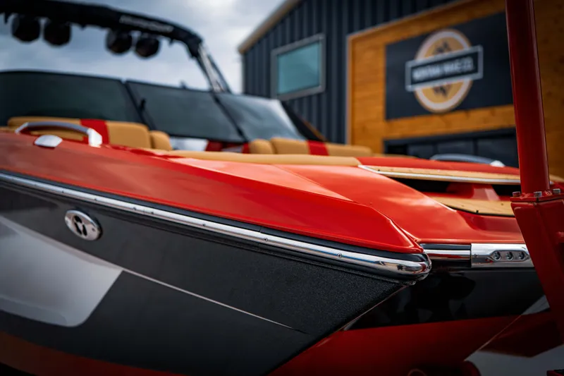 Slide: The Image of 2023 MasterCraft X24 boat, red and black finish, close-up view. - 7