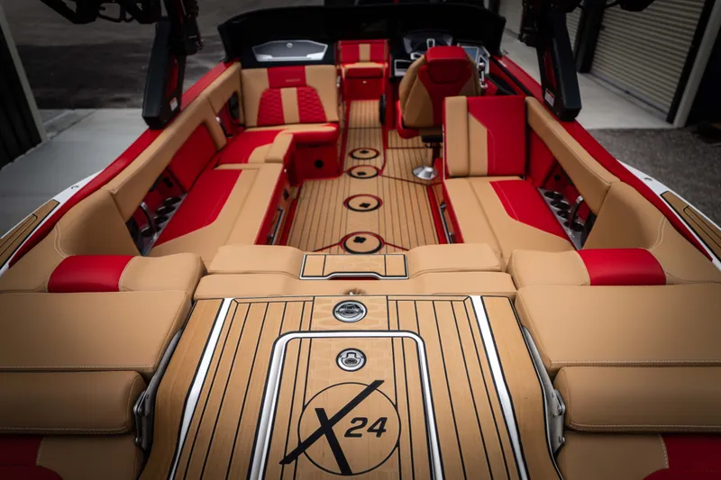 Slide: The Image of 2023 MasterCraft X24 interior with red and beige seating. - 9