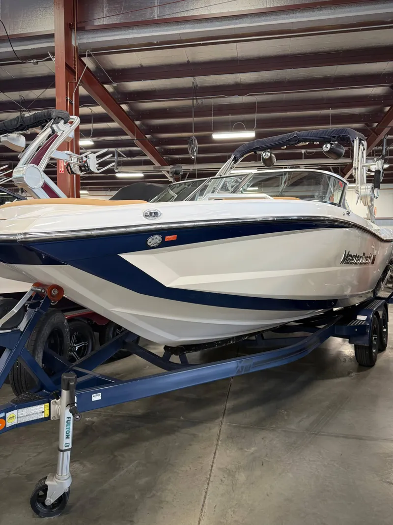 The Image of 2021 MasterCraft XT22 boat in a warehouse. - 1