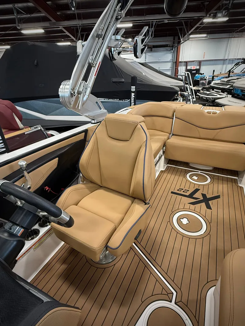 Slide: The Image of Interior of a 2021 MasterCraft XT22 boat with beige seating. - 11