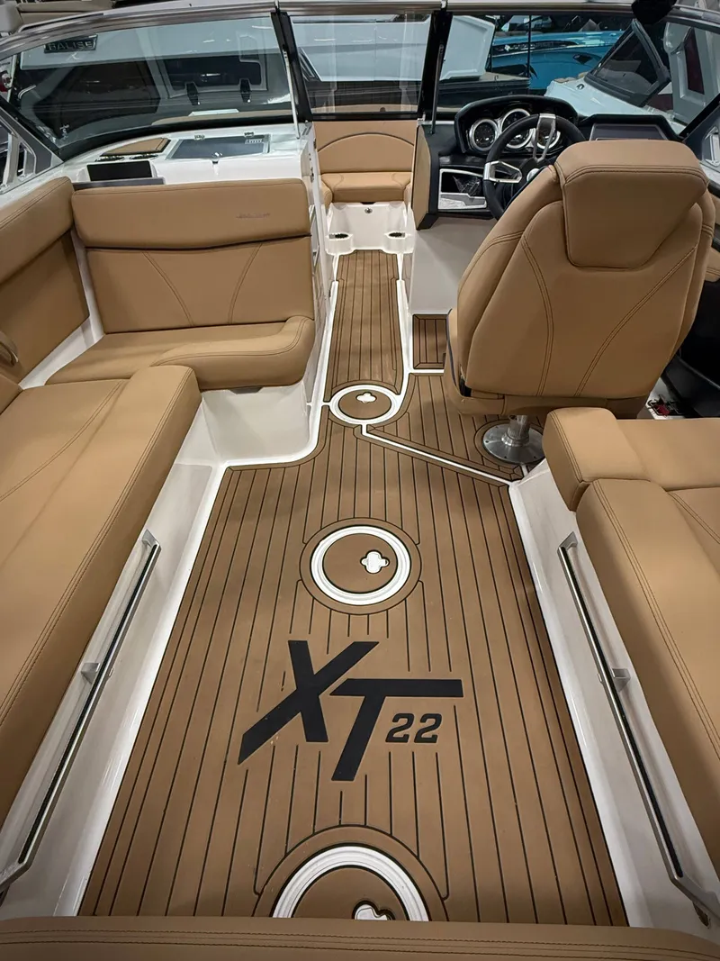 Slide: The Image of Interior of a 2021 MasterCraft XT22 boat with brown seating. - 12