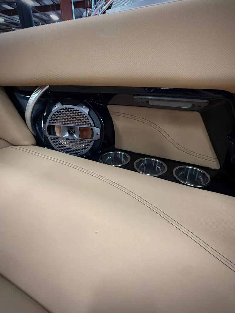 Slide: The Image of Interior of a 2021 MasterCraft XT22 with speaker and cup holders. - 15