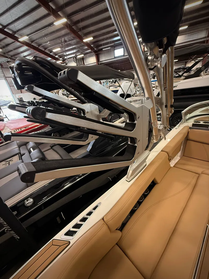Slide: The Image of 2021 MasterCraft XT22 with wakeboard rack in a warehouse. - 19