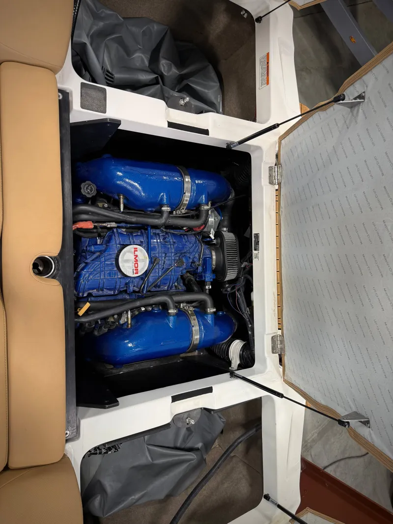 Slide: The Image of Engine compartment of a 2021 MasterCraft XT22 boat with blue engine. - 22