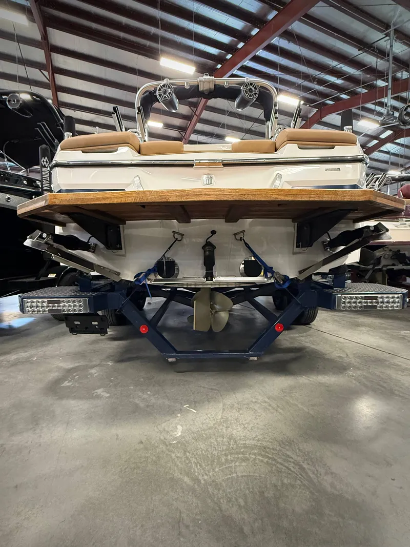 Slide: The Image of Rear view of a 2021 MasterCraft XT22 boat in a warehouse. - 4
