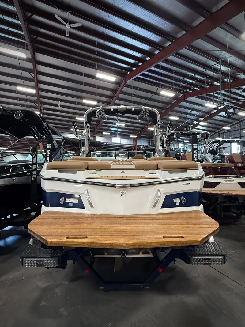 Slide: The Image of 2021 MasterCraft XT22 boat in showroom. - 5