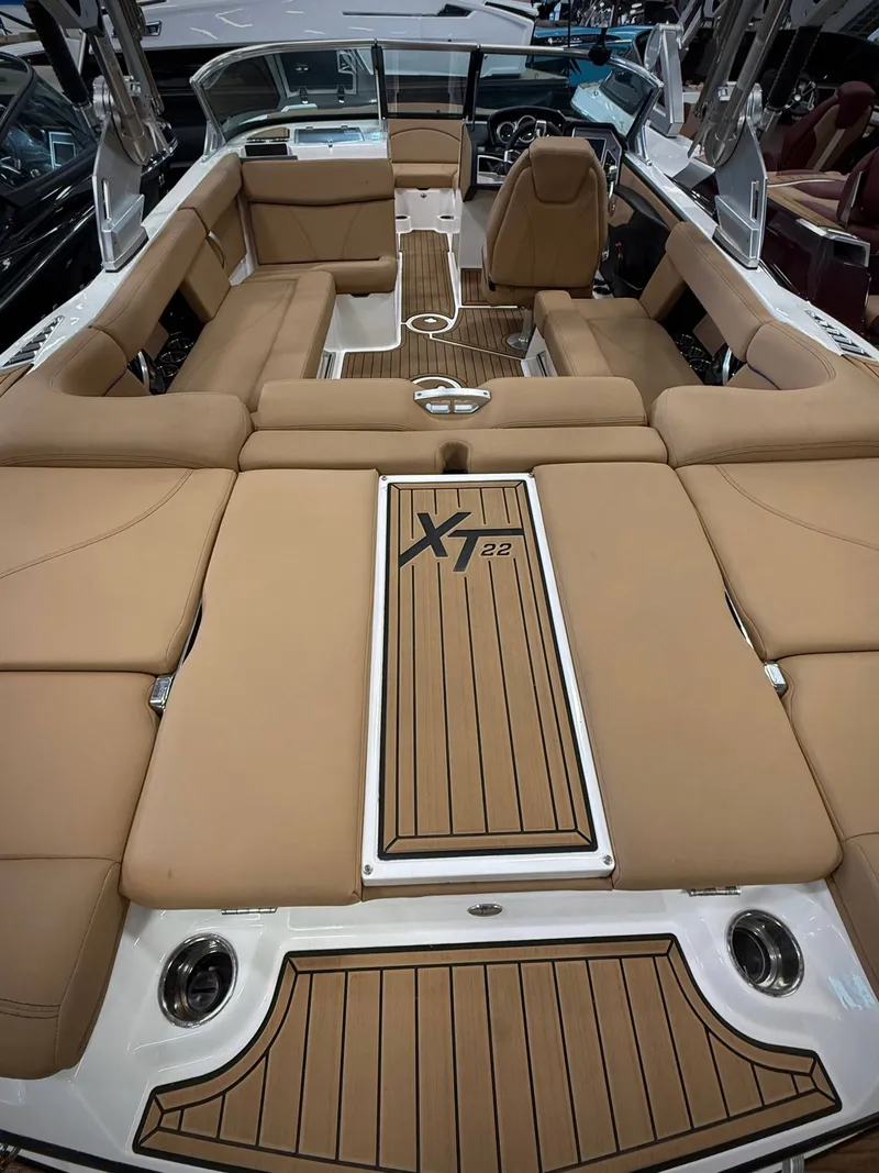 Slide: The Image of Interior of a 2021 MasterCraft XT22 boat with brown seating. - 6