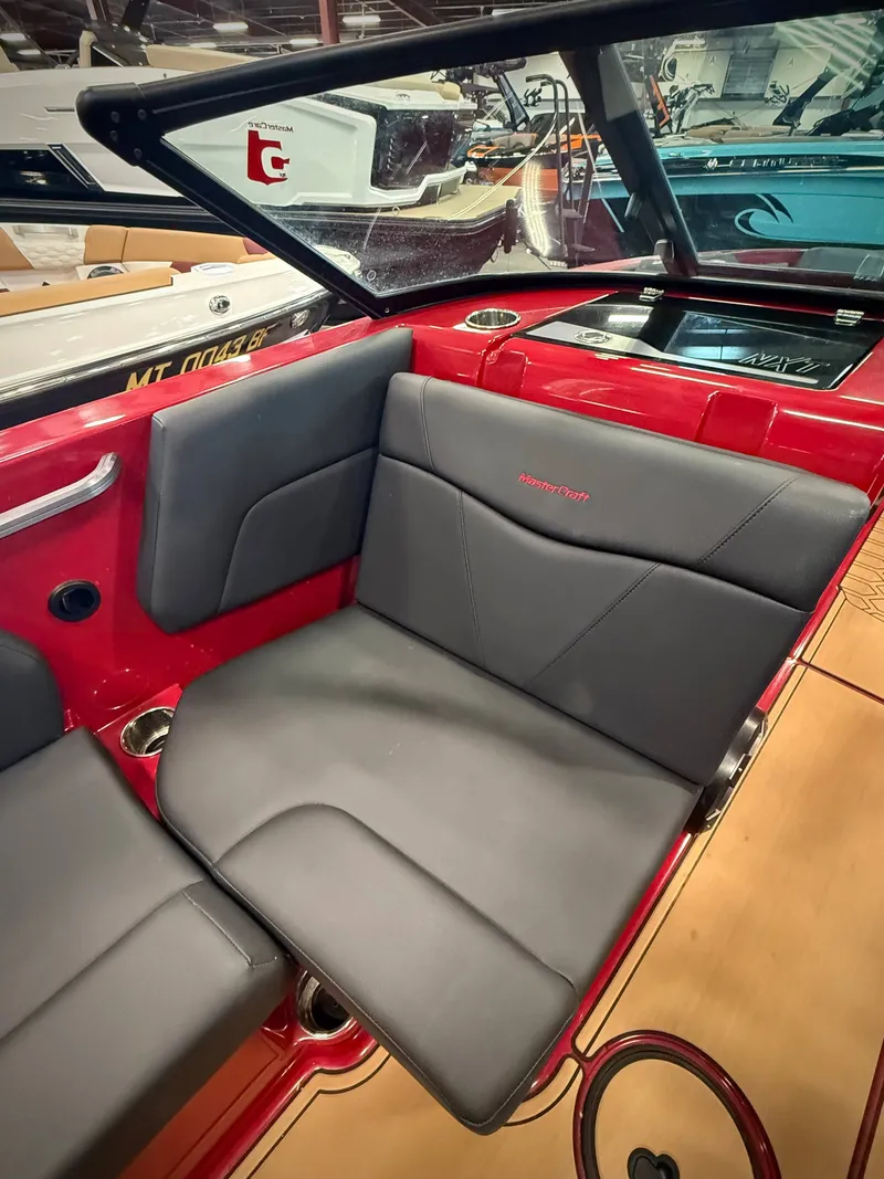 Slide: The Image of Interior of a 2022 MasterCraft NXT24 boat with black seating. - 10