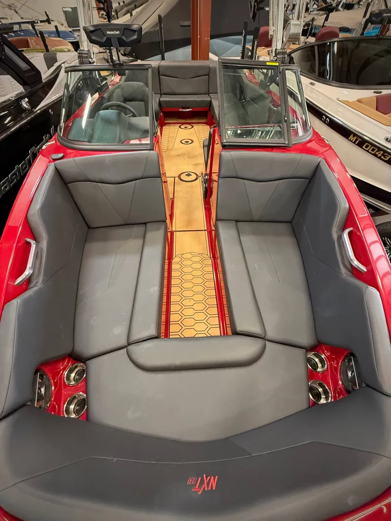 Slide: The Image of Interior of a 2022 MasterCraft NXT24 boat with gray seating. - 11