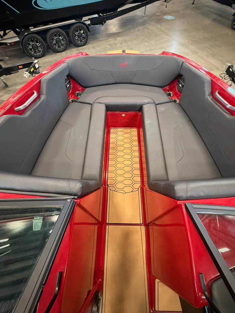 Slide: The Image of Interior of a 2022 MasterCraft NXT24 boat with red and gray seating. - 12