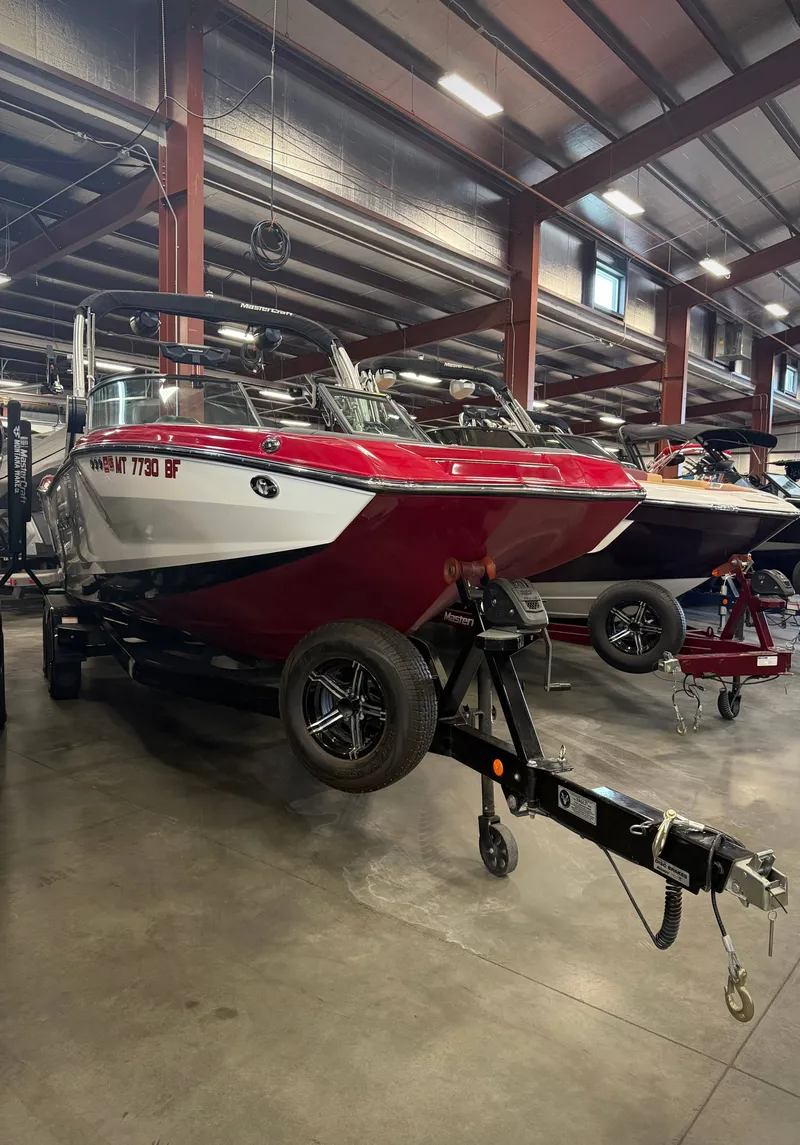 Slide: The Image of 2022 MasterCraft NXT24 boat in warehouse on trailer. - 3
