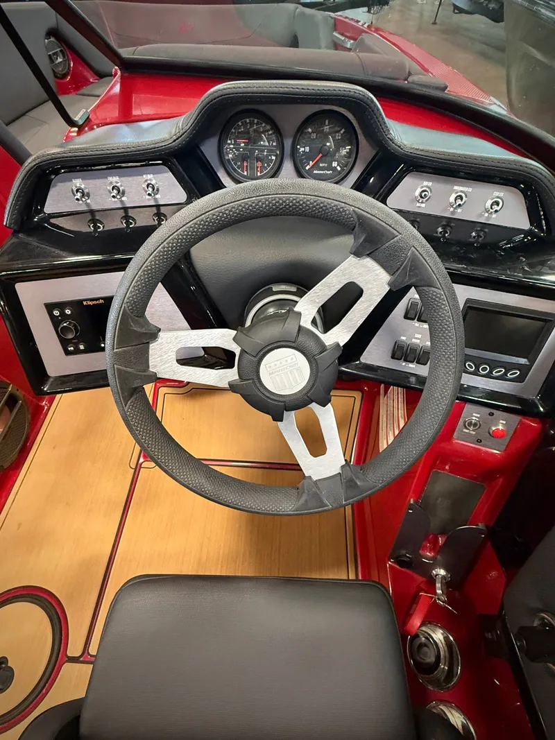 Slide: The Image of Steering wheel and dashboard of a 2022 MasterCraft NXT24 boat. - 7
