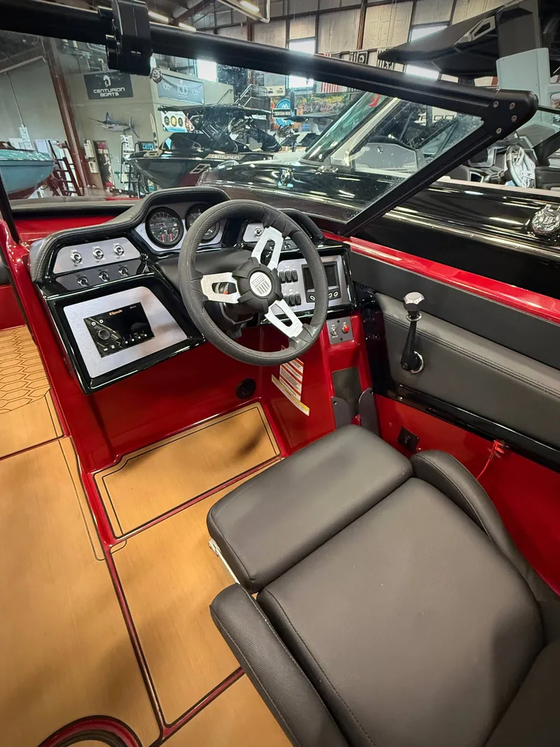 Slide: The Image of Interior of a 2022 MasterCraft NXT24 boat with red and black design. - 8