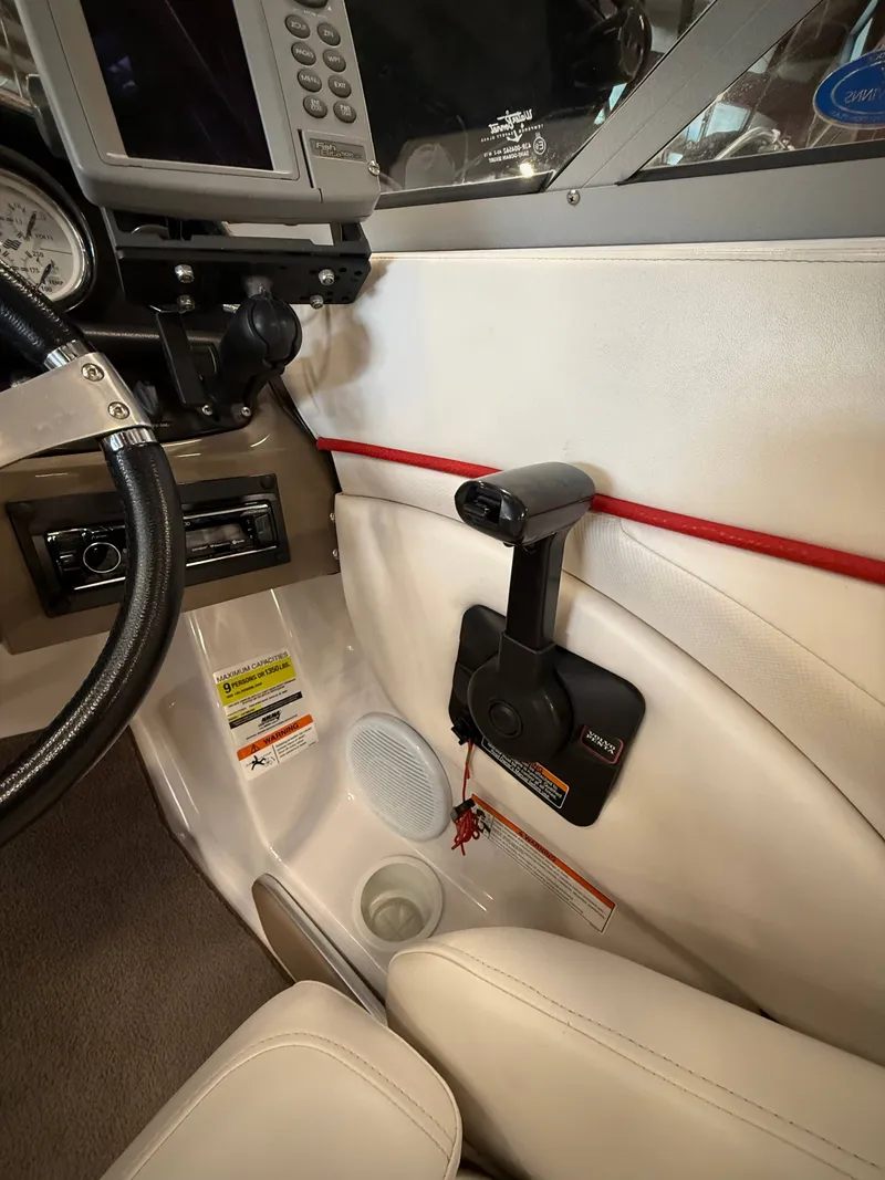 Slide: The Image of Interior of a 2007 Four Winns 210 Horizon boat with control console. - 12