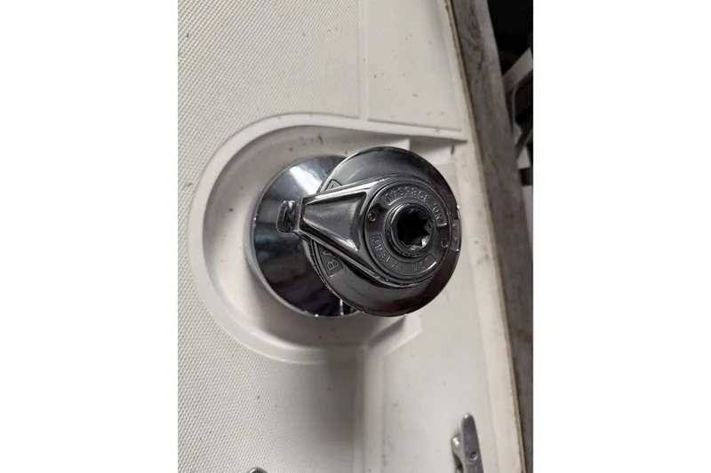 Slide: The Image of Chrome winch handle on a 1986 CAL 33 sailboat deck. - 12