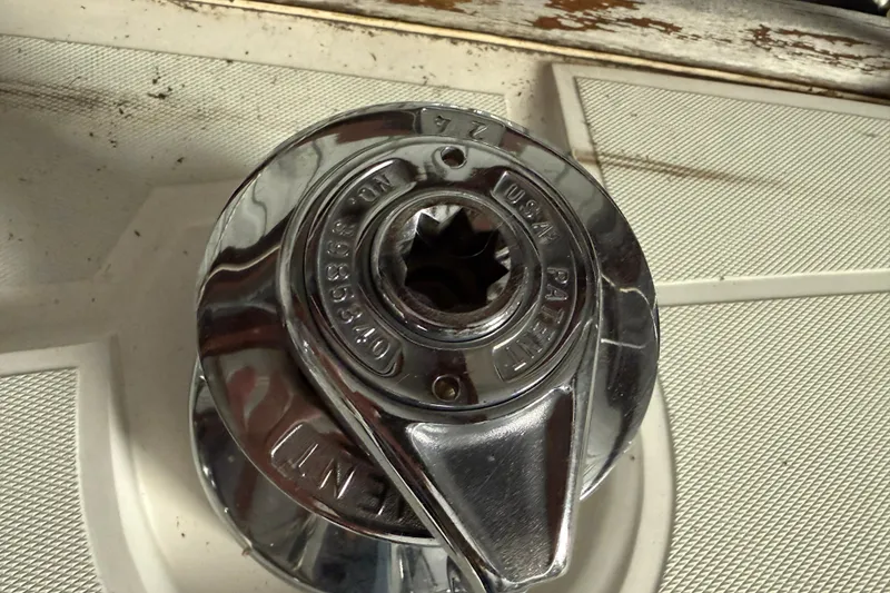 Slide: The Image of Close-up of a shiny metal winch on a 1986 CAL 33. - 18
