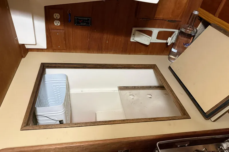 Slide: The Image of Interior of a 1986 CAL 33 sailboat galley with storage compartment. - 21