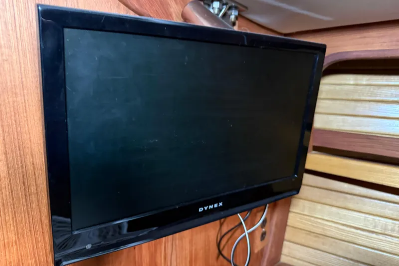 Slide: The Image of Flat-screen TV mounted on wooden interior of 1986 CAL 33 sailboat. - 28