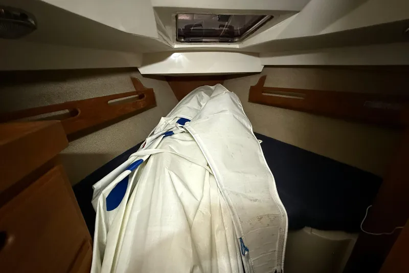 Slide: The Image of Interior of 1986 CAL 33 sailboat cabin with folded sail on bed. - 32